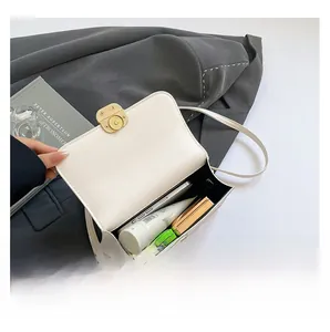 Top view of white flap crossbody bag showing spacious interior for daily essentials