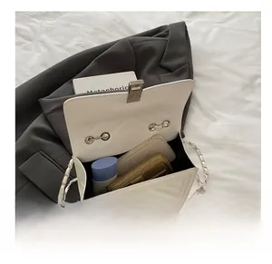 Internal view of a white quilted chain bag showing capacity for phone and cosmetics