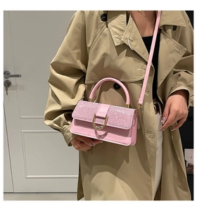 Detail showing pink sequin flap and gold buckle on a stylish mini crossbody bag