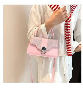 Macro detail of pink textured leather bag with sequin flap and silver ring lock