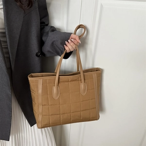 Khaki quilted tote bag with large checkered stitching and sturdy reinforced shoulder straps