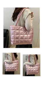Macro shot of pink quilted puffer tote bag detail with metallic finish and soft shoulder strap