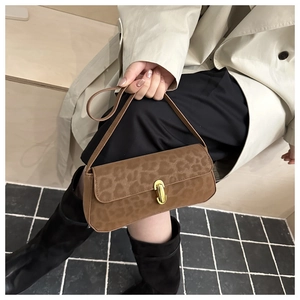 Détail du sac à bandoulière en daim imprimé léopard avec fermoir en métal doré poli