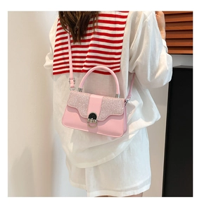 Detailed view of pink mini box bag with glitter flap and silver metallic clasp closure