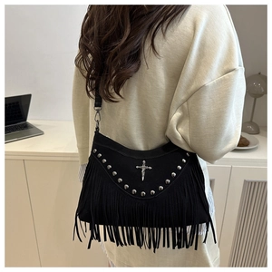 Dettaglio borsa a tracolla punk nera con borchie argento, logo a croce e lunghe frange