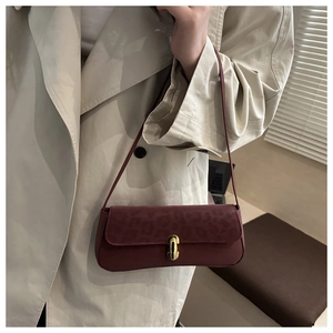 Détail du sac bandoulière bordeaux en cuir gaufré léopard avec fermoir rotatif doré