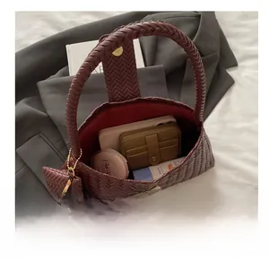 Interior view of burgundy woven bag showing capacity for phone and wallet storage