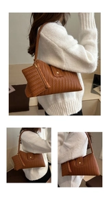 Close-up of brown woven texture shoulder bag with matching mini pouch and gold chain