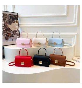 Detail view of mini square handbags in six colors with elegant gold metal locks and handles