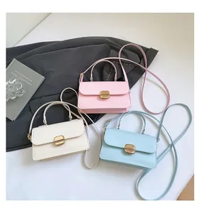 Three elegant leather crossbody bags in pastel colors with gold hardware buckles