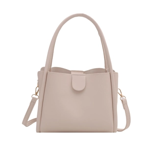 Minimalist beige pink bucket bag in smooth PU leather with top handle and shoulder strap