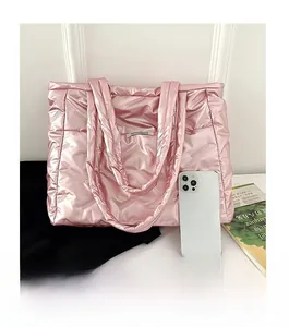 Détail du sac cabas matelassé rose avec étiquette mode comparé à un smartphone