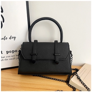 Vue détaillée de la texture cuir Saffiano noir avec chaîne et lanières noir mat