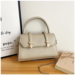 Détail du sac doré champagne en cuir Saffiano avec boucle métallique en flèche