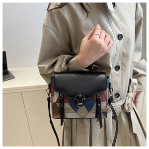 Close-up of geometric patchwork shoulder bag with retro metal rotary lock and leather texture