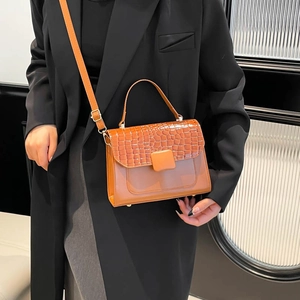 Brown crocodile embossed leather crossbody bag with top handle and adjustable strap