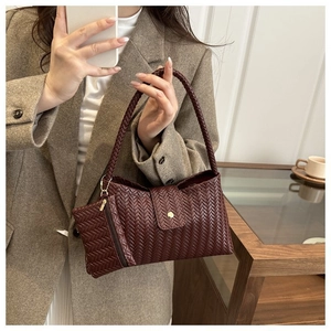 Detail of woven burgundy shoulder bag with matching coin purse and magnetic clasp closure