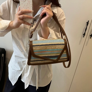 Bohemian multicolored woven crossbody bag with striped pattern and brown leather trim
