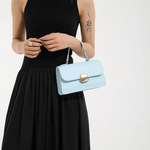 Minimalist light blue square handbag with gold rotating buckle and leather shoulder strap