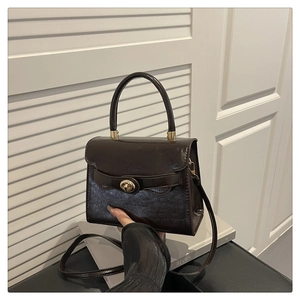 Deep brown glossy patent leather handbag with gold arc buckle and top handle for women