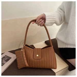 Detail of caramel woven texture shoulder bag set with matching mini zipper pouch