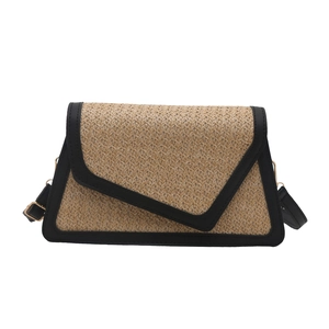 Straw woven shoulder bag with black trim and asymmetric flap design for women
