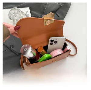 Internal capacity of caramel stone pattern bag showing phone and cosmetics