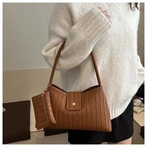 Detailed view of brown woven hobo bag texture with matching mini pouch and shoulder strap