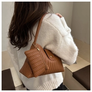 Detail of a brown woven hobo shoulder bag with a small matching zip coin purse pendant