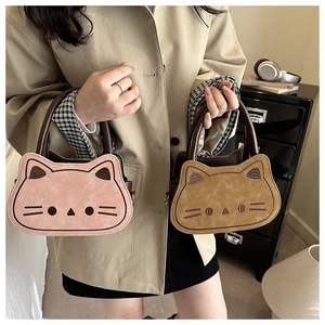 Detail of pink and brown cute cat crossbody bags with embroidery and leather handles