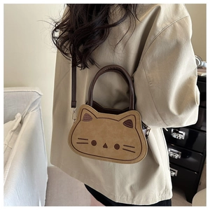 Rear view of a child wearing the cute khaki cat shaped crossbody bag with brown handles