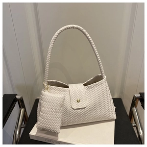 Detailed view of cream woven texture underarm bag with a matching small pouch set