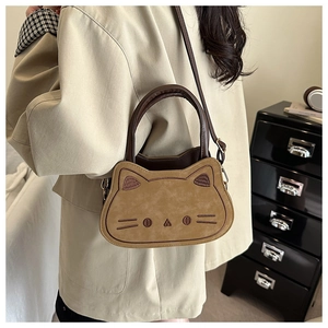 Detail of khaki cat-shaped kids crossbody bag with embroidery and plush texture