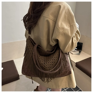 Dettaglio della trama in maglia e base leopardata di una borsa marrone con frange