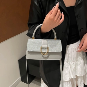 Chic grey sequin crossbody bag with gold handle and metallic horseshoe buckle closure
