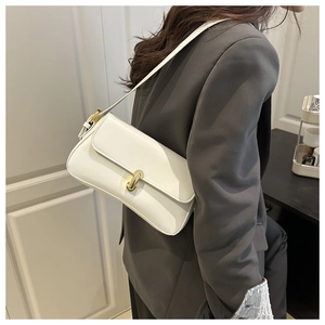 Chic white leather shoulder bag with gold metal buckle detail on a female model