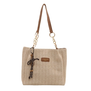 Beige woven straw tote bag with brown leather straps and gold chain link details