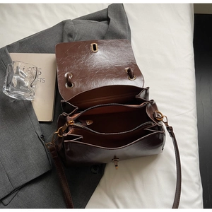 Overhead view showing organized interior compartments of the brown faux suede handbag