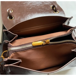 Macro view of the faux suede handbag interior with zipper pocket and vintage hardware