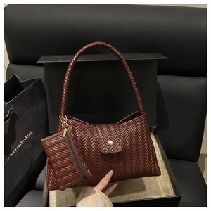 Detail of dark brown woven leather shoulder bag with gold snap and matching coin pouch