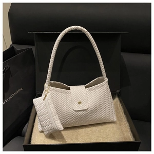 White woven shoulder bag with chunky braided strap and matching pouch in a gift box