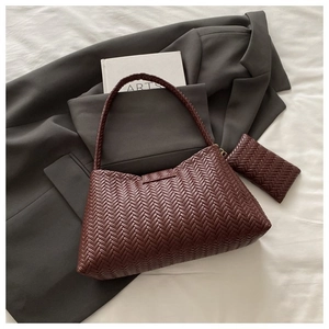 Detailed close-up of dark wine red woven leather hobo bag and matching clutch set