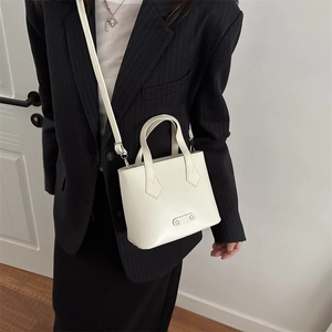 Chic off-white PU leather bucket bag with metal logo and adjustable strap for women