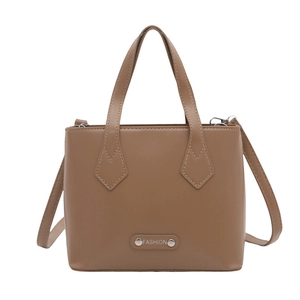 Brown leather-like fashion bucket tote bag with metal brand plate and shoulder strap