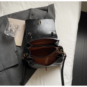 Detailed interior of black suede tote showing double compartments and zipper pocket