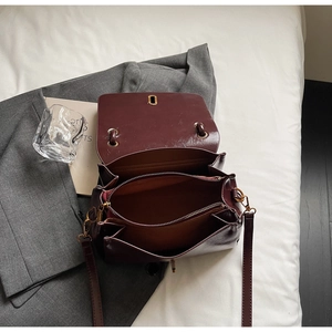 Detail view of burgundy leather bag interior showing dual main compartments and zipper divider