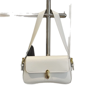 Minimalist beige baguette underarm bag with half-moon shape and gold oval buckle clasp