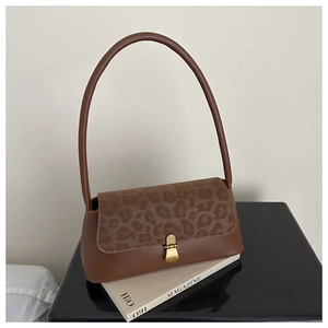 Detail of vintage brown leopard print shoulder bag with metallic clasp closure