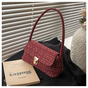Detailed close-up of dark red tweed underarm bag with gold-tone hardware and leather strap