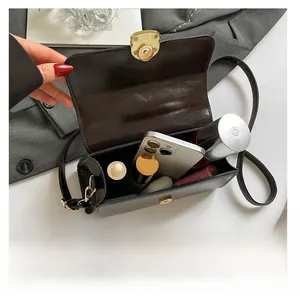 Top view of deep brown faux leather crossbody bag showing spacious interior capacity
